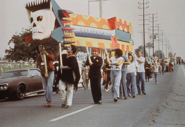 A group of marchers holding a large object